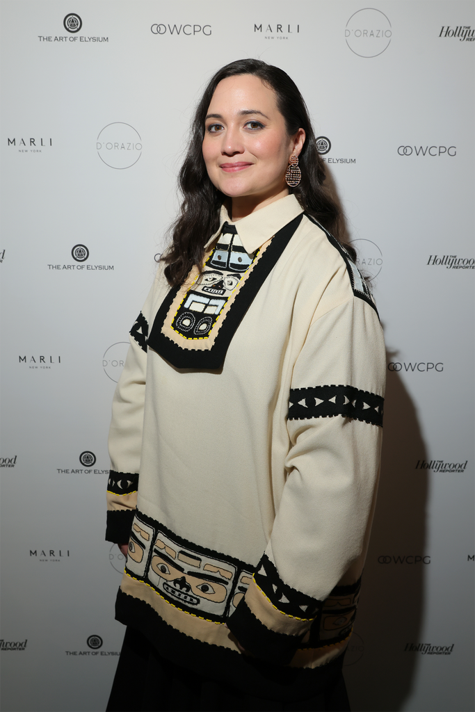 Actress Lily Gladstone on the red carpet wearing a traditional Native American garment. 