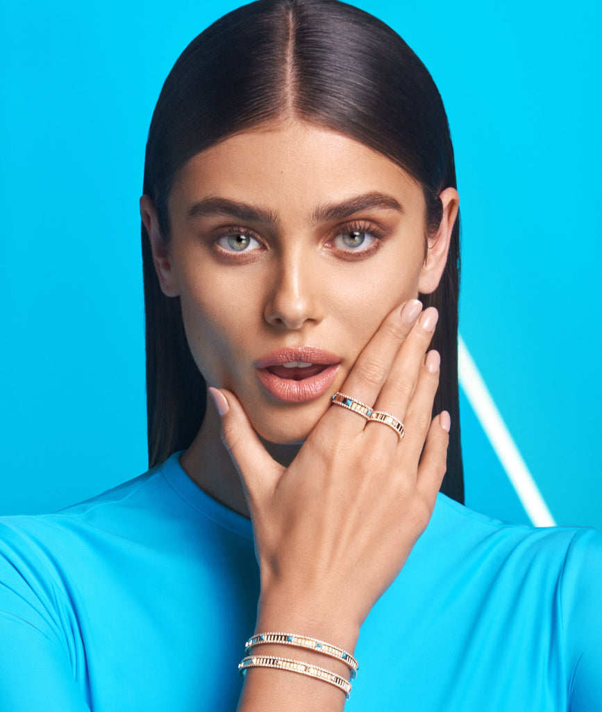 Taylor Hill in blue with hand holding face