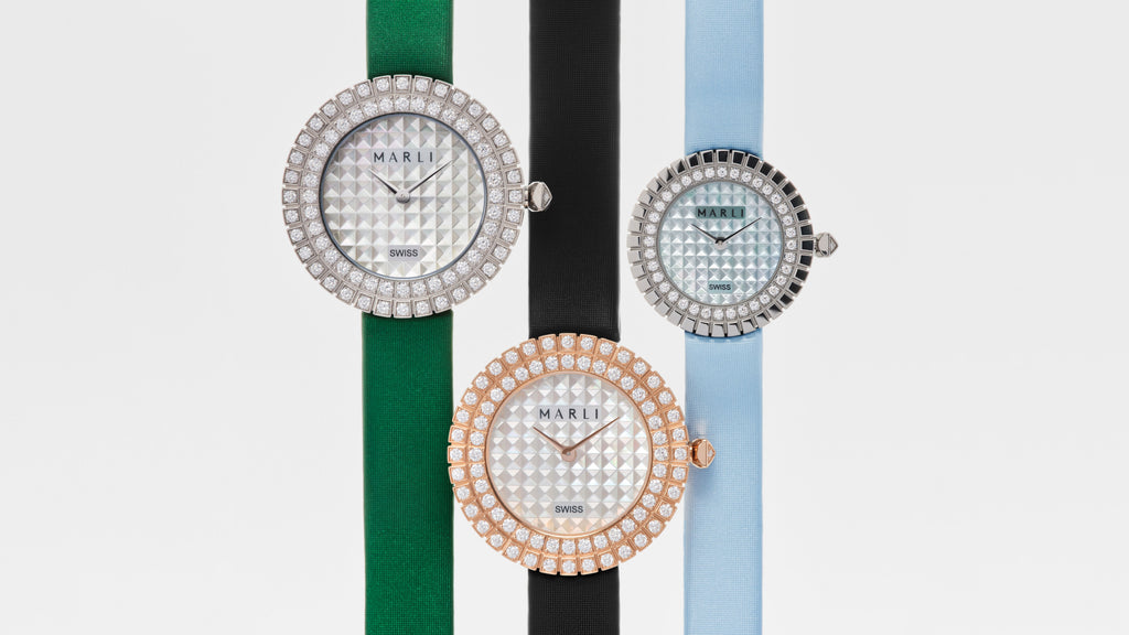 Three watches with decorative faces and colorful straps on a white background