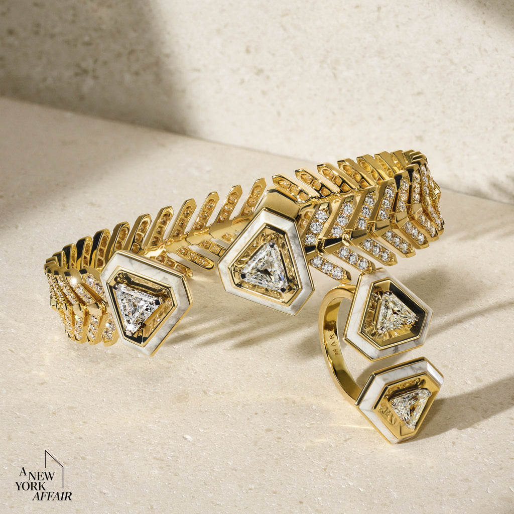 Gold and silver bracelet with geometric design on a beige surface, featuring 'A New York Affair' brand.