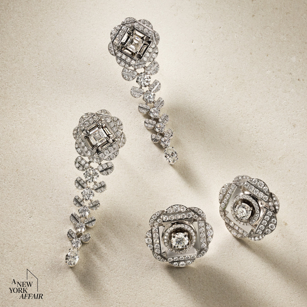 Set of silver earrings with diamond-like stones on a beige background