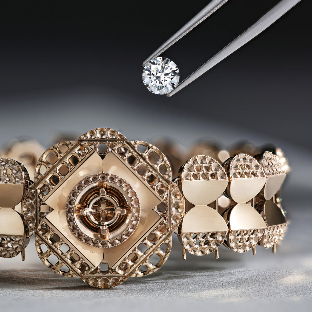 Close-up of a diamond being held above a decorative gold earring.