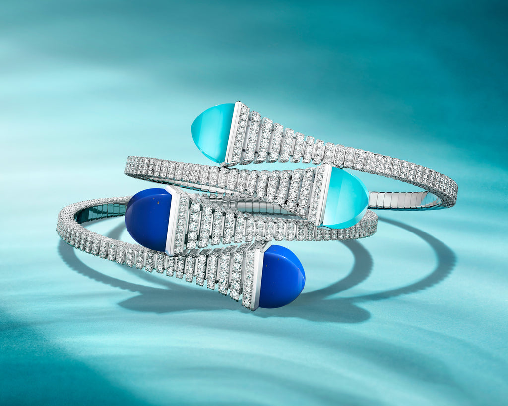 Silver bracelet with blue and turquoise stones on a teal background