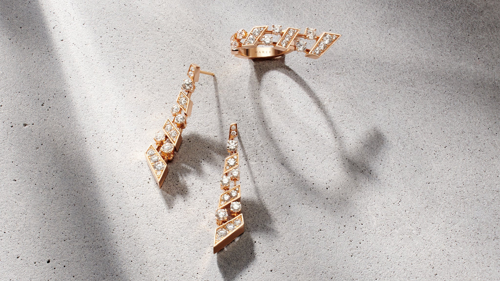 A pair of rose gold statement earrings with diamonds and a matching ring. 