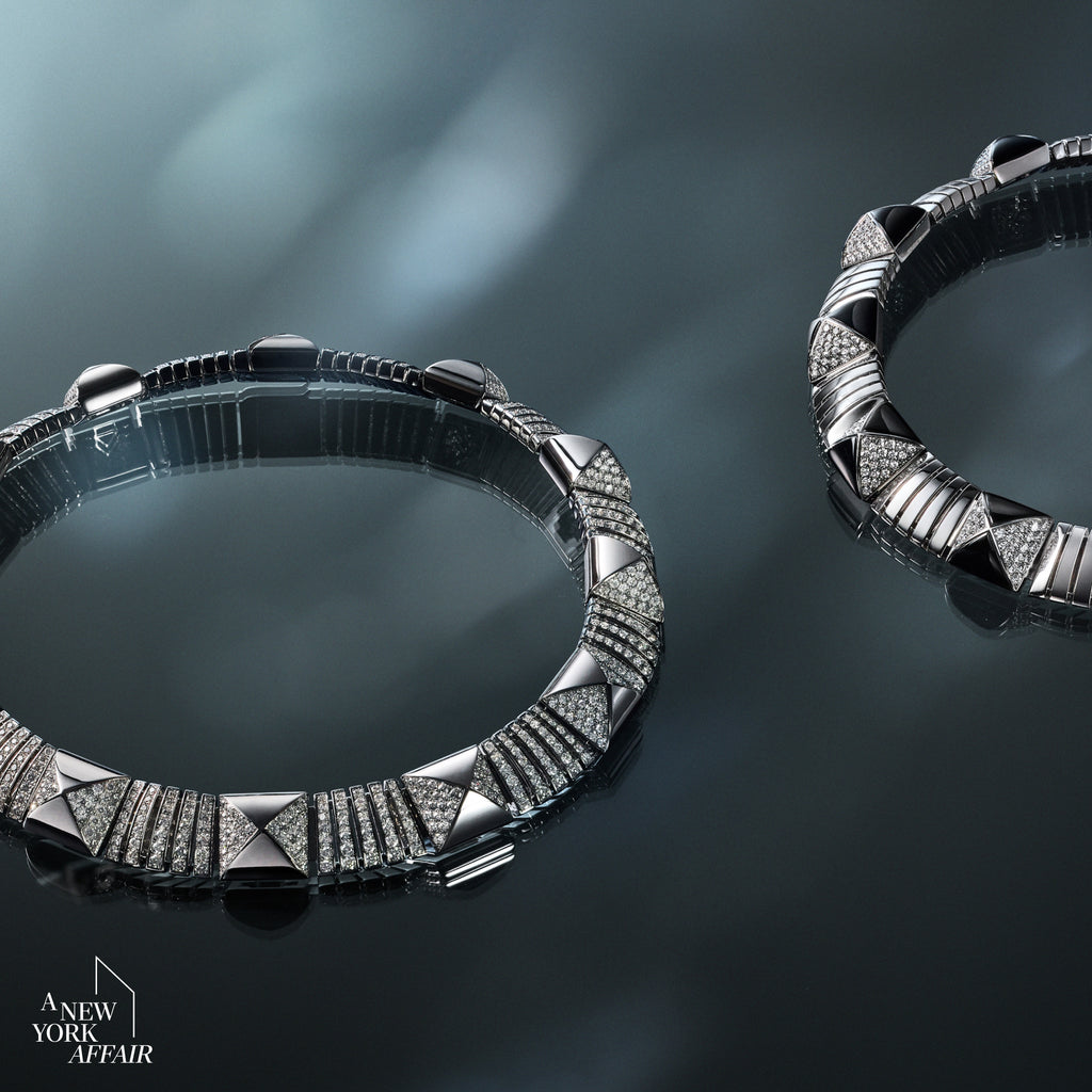 Two silver bracelets on a reflective dark surface with 'A New York Affair' branding.