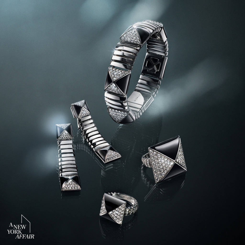 Silver jewelry set including a ring, bracelet, and earrings on a dark background.