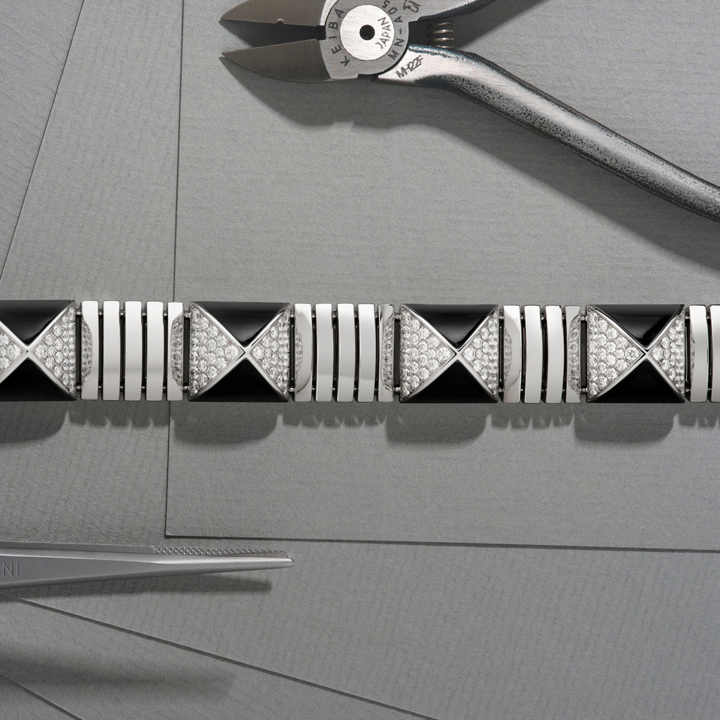 Decorative black and white patterned strip with tools on a gray surface