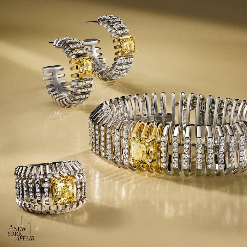 Gold and silver jewelry set with yellow gemstones on a beige background, featuring 'A New York Affair' brand.